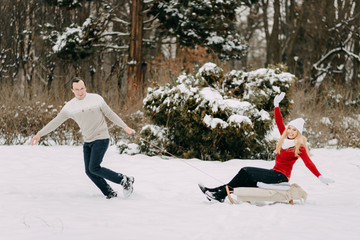 Happy Couple Having Fun Outdoors in Snow Park. Winter Vacation