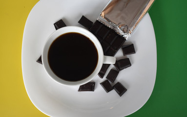 Coffee in a white Cup with pieces of chocolate.