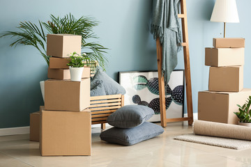 Belongings and moving boxes near wall in room