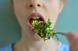 © Cohncentric - Crop close up shot of girl eating salad with a fork