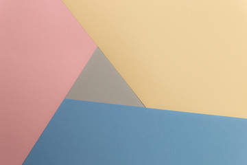 Multicolor background from cardboard of different colors. Pastel paper color for background. Colorful abstract geometric shapes. Pastel colored paper texture minimalism background. Pink, Blue, Grey.