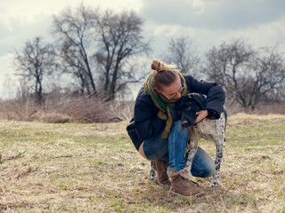 girl walking a big blind dog in the spring