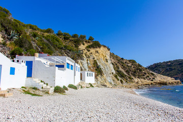 Wall Mural - Small white fishermen houses in Barraca Portitxol beach, in Javea, Spain