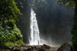 Adventure seeker at beautiful jungle waterfall
