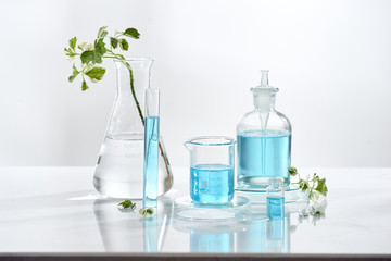 Wall Mural - laboratory glass equipment with natural ingredients on white background