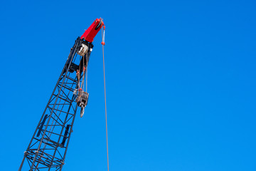 Construction crane in action with blue sky in Miami