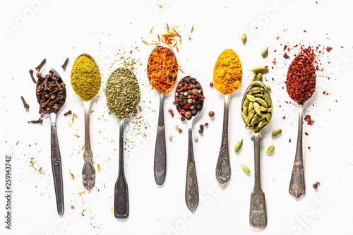 Cuadros en Lienzo Set of indian spices in spoons on white