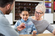 © ReeldealHD images - Young girl choosing glasses at the optician