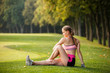 © Olga Mishyna - sport girl making exercises outdoors. Young sport woman in a park. Sport and fitness on open air. Exercise lunge leg on the grass and stretching