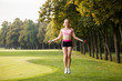 © Olga Mishyna - sport girl making exercises outdoors. Young sport woman in a park. Sport and fitness on open air. Exercise lunge leg on the grass and stretching