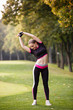 © Olga Mishyna - sport girl making exercises outdoors. Young sport woman in a park. Sport and fitness on open air. Exercise lunge leg on the grass and stretching