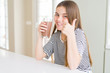 © Krakenimages.com - Beautiful young girl kid drinking fresh tasty chocolate milkshake as snack happy with big smile doing ok sign, thumb up with fingers, excellent sign