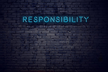 brick wall and neon sign with text responsibility