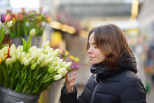 Beautiful Young Woman Selecting Fresh Tulips At Famous Amsterdam Flower Market (Bloemenmarkt).