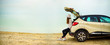 canvas print picture - View of young woman traveler looking at sea sunset, sitting on hatchback car with the copy space. Banner