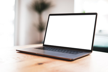Poster - Laptop blank screen mockup on table in living room - front view