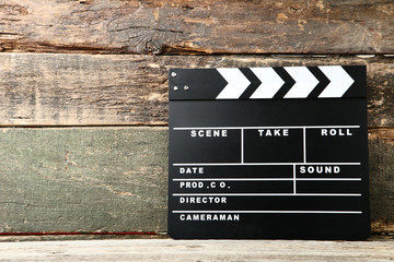 Clapper board on grey wooden table