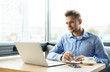 © Cressida studio - Stylish young man calling by the phone to solve business problems. Online consultation by phone. Freelancer discussing the development and planning of his online project. Outsourcing. Mobile services.