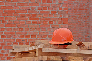 Construction helmet close-up on a construction site. Construction helmet as protection while working at a construction site. Safety first project of worker.