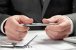 © soleg - Businessman working in an office. Hands and documents closeup.