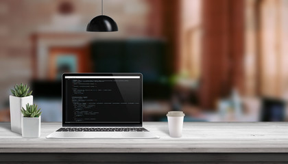Fototapete - Web development studio concept. Laptop vith script code editor. Copy space beside.