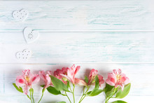 Frame For Greeting Text With Natural Flowers And Hearts. Background For A Banner Of White Color With Pink Flowers Of Alstroemeria. Flat Lay, Top View.