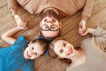 Wall Mural - happy family mother father and child daughter laughing   at home