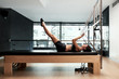 © guille Faingold/Stocksy - Muscular woman having workout on pilates table