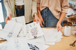 © Wells/Stocksy - Two young female fashion designers working together at the design studio