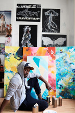 Portrait Of Painter Surrounded By Artwork At His Studio.