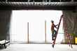 © Jetta Productions/Stocksy - Construction worker on ladder