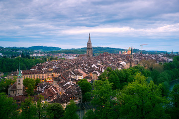 Wall Mural - Aerial view of the Bern old town with the Aare river flowing around the town at night in Bern, Switzerland.