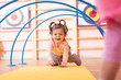 © Oksana Kuzmina - Baby girl crawling on mat in gym class. Lifestyle concept of children activity.