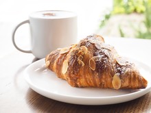 Freshly Baked Almond Croissant With Cafe Latte