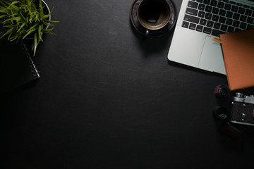 Office leather desk with laptop, camera, coffee and copy space