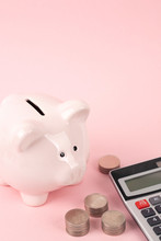 Pink Piggy Bank And Coins With Calculator