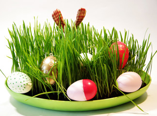 Easter congratulation card with bright flowers, greens and eggs.