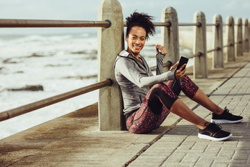 Wall Mural - Female runner resting after exercising