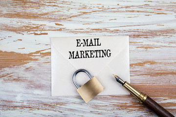 Wall Mural - E-mail marketing concept. Paper letter, padlock and pen on a wooden table