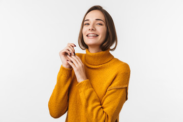 Lovely young girl wearing braces standing isolated