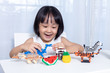 Leinwandbild Motiv Asian Chinese little girl playing puzzle toys