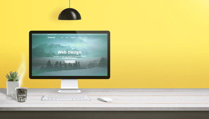 Aufkleber - Web design studio work desk with computer display, keyboard, mouse, plant and cup of coffee. Copy space beside on yellow wall.