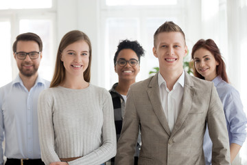 Wall Mural - Business people standing together looking at camera in office