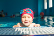 © Dmitry Naumov - Child in a pool narrows eyes enjoying swimming