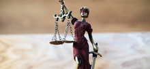 Themis , Symbol Of Law And Justice On Wooden Background