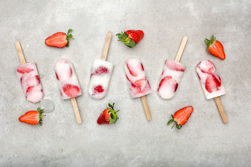 Wall Mural - Fresh strawberry popsicles with yogurt and strawberries. Ice pops, flat lay, top view