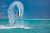 Professional pro fly board rider in tropical sea, water sports concept background. Summer vacation fun outdoor sport