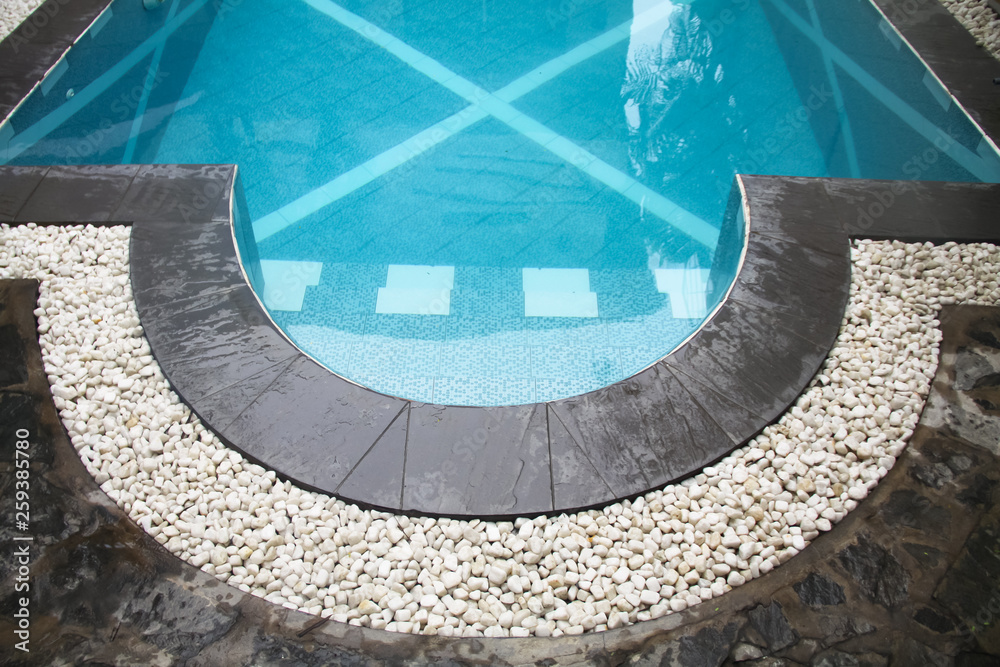 curve swimming pool gutter with white gravels on top and black slate ...