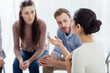 © LIGHTFIELD STUDIOS - selective focus of woman gesturing with hand during group therapy session