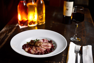 Wall Mural - fried duck meat with berry sauce on a white plate